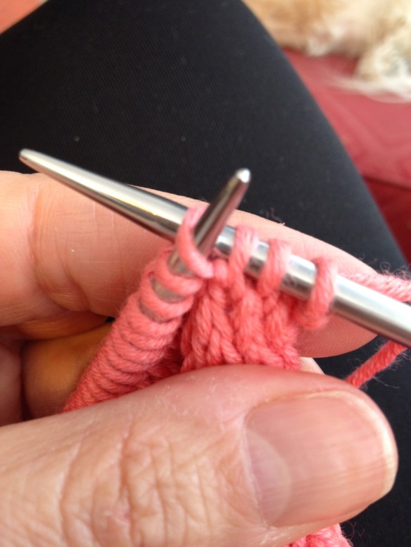 I've knitted two stitches and am knitting into the front and back of the third stitch. I've already knitted into the front and now I'm knitting into the back.